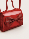 Detaliu fundă glitter roșie pe geanta elegantă pentru fetițe